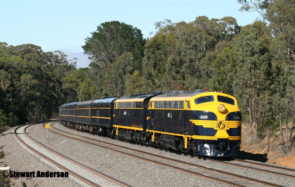 VR blue/yellow painted Seymour Rail Heritage Centre B74 and S303 head the special 70th anniversary of Spirit of Progress passenger train near Broadford (Victoria, Australia) on 25 November 2007 (picture courtesy and copyright of Stewart Anderson).